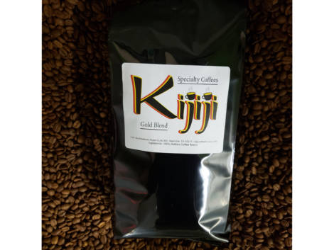 Bag of Kijiji Gold Blend Coffee laying on top of coffee beans
