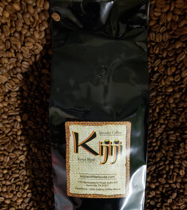 Bag of Kijiji Kenya Blend Coffee laying on top of coffee beans