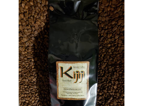 Bag of Kijiji Kenya Blend Coffee laying on top of coffee beans